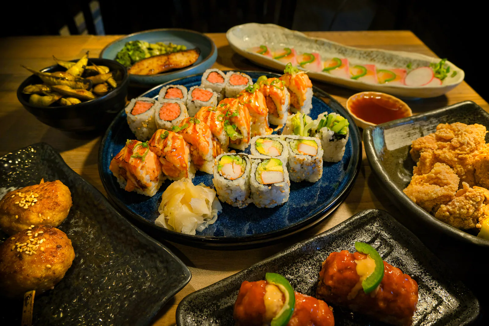 Sushi rolls and small plates across the table